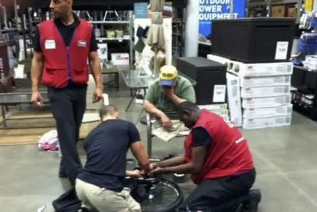 Michael Sulsona at Lowe's, with employees helping fix his wheelchair